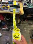 a person holding a piece of tape with the word zero
